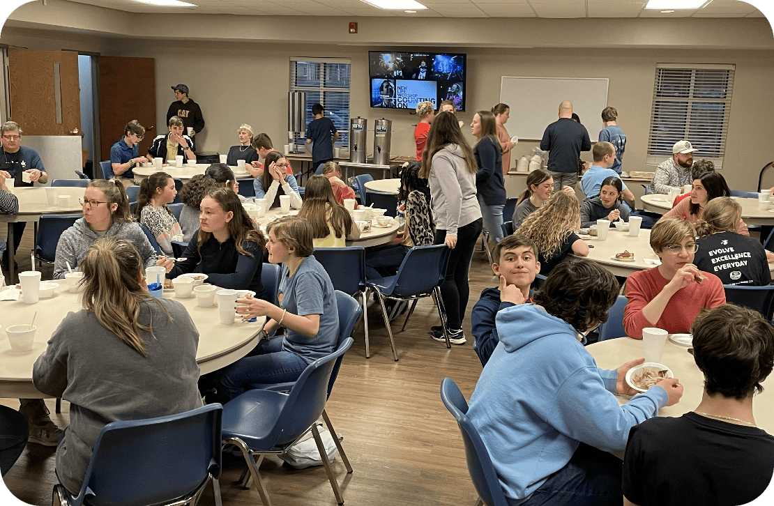 Students talking and eating food in a hall